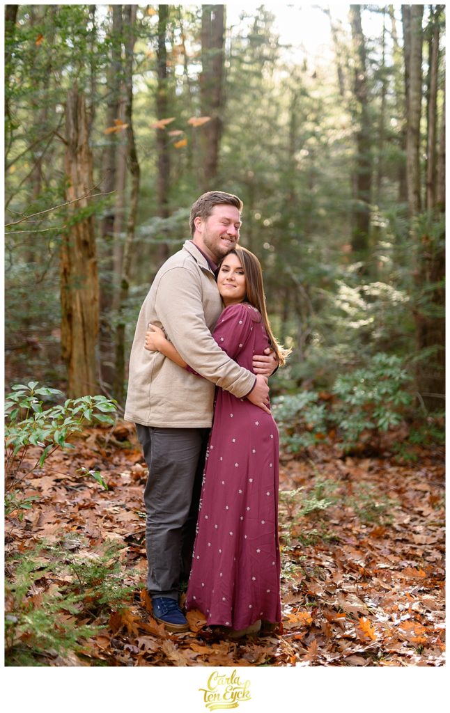 A couple snuggles on their engagement session at Valley View Farms in Haydenville MA
