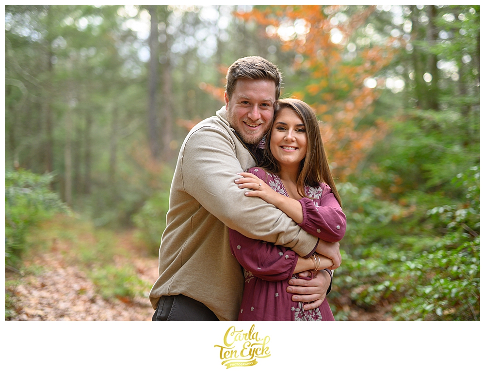 A couple embraces at their engagement session on Valley View Farms in Haydenville MA