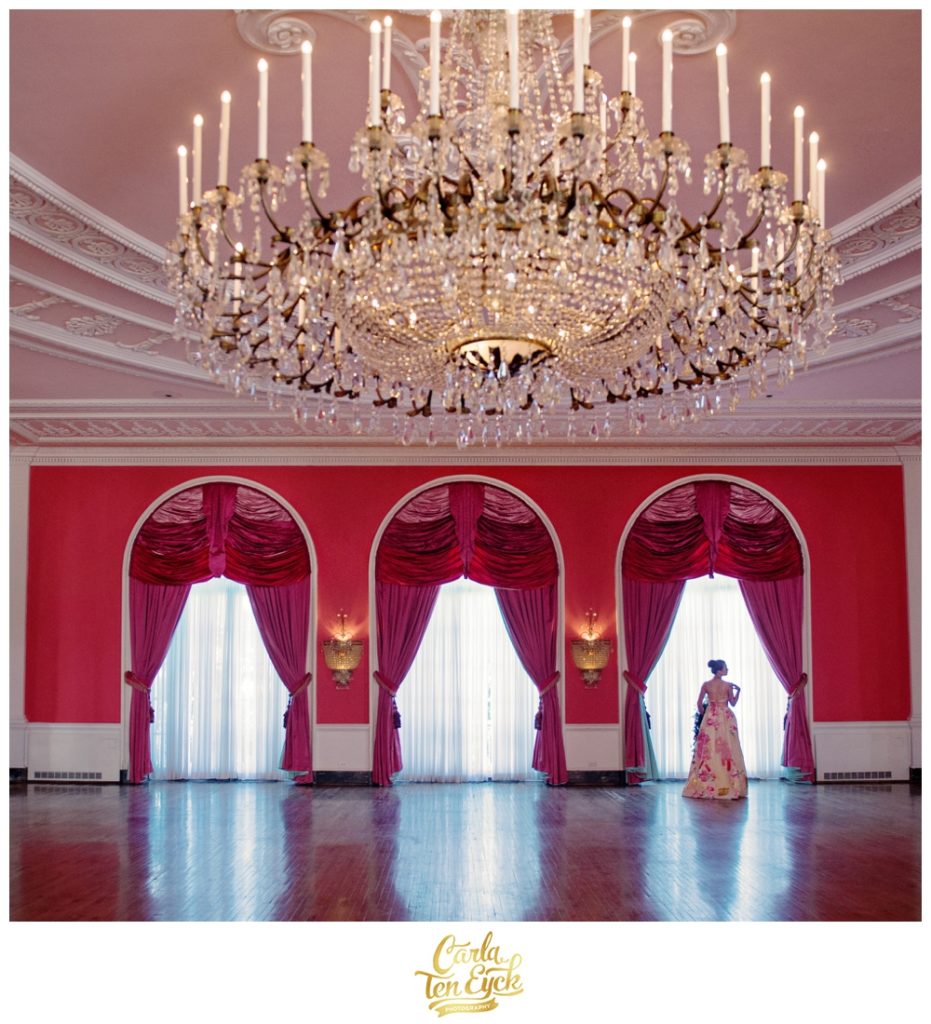 A bride poses in the pink ballroom at The Greenbrier in West Virginia