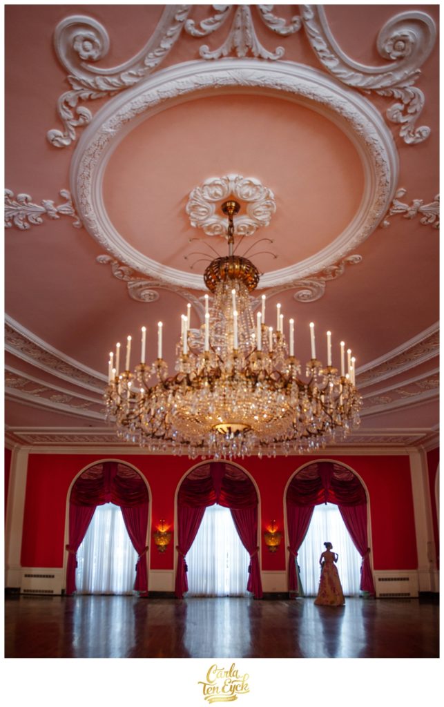 A bride poses in the pink ballroom at The Greenbrier in West Virginia