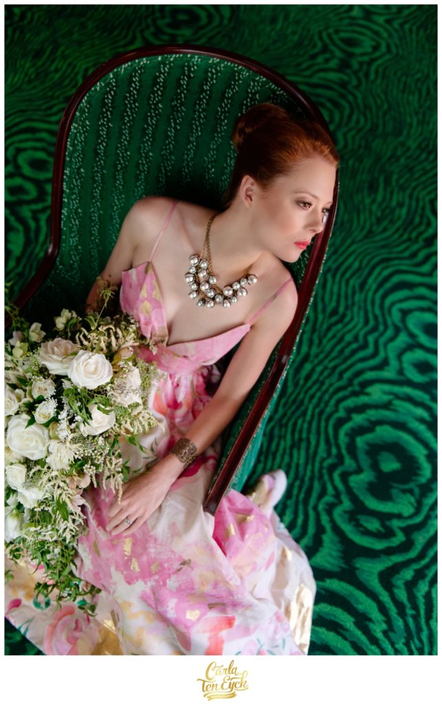 A bride poses on a green chaise at The Greenbrier in West Virginia