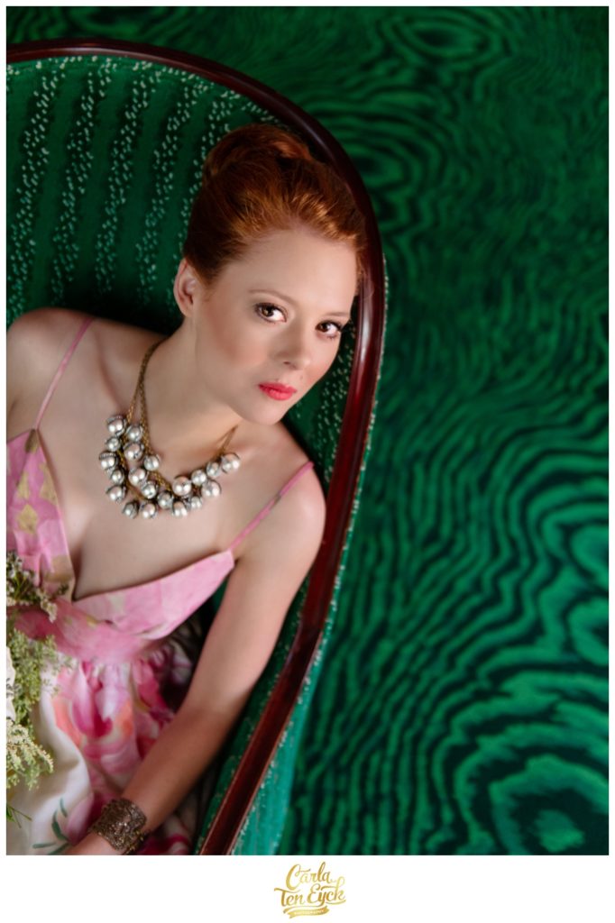 A bride poses on a green chaise at The Greenbrier in West Virginia