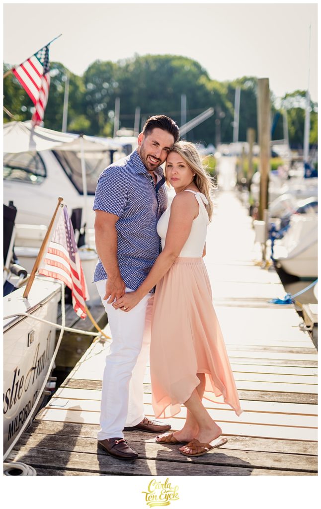 Couple poses for their Milford CT engagement session on the boat docks 