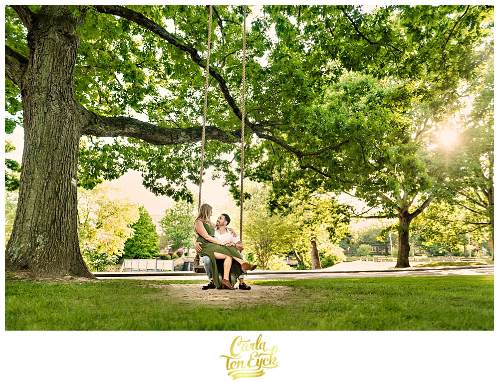 A couple sits on a swing during their Milford Ct engagement session