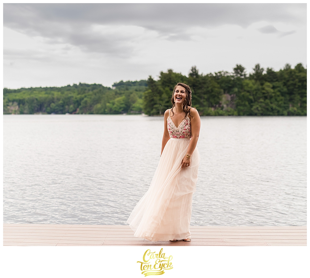 A bride laughs on a dock during her micro wedding during covid 19