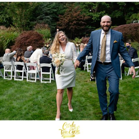 Bride and groom celebrate after their intimate backyard wedding
