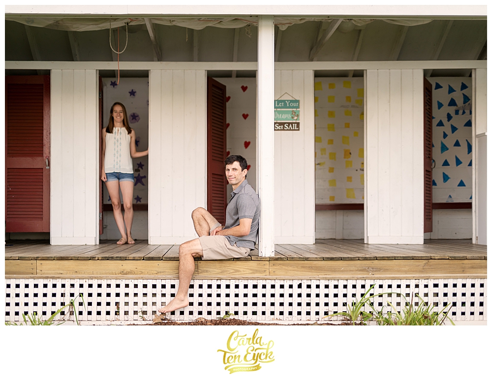 A couple relaxes on the beach during their engagement session on Lake Waramaug CT