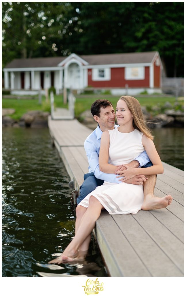Couple relaxes on the dock on Lake Waramaug CT during their engagement session