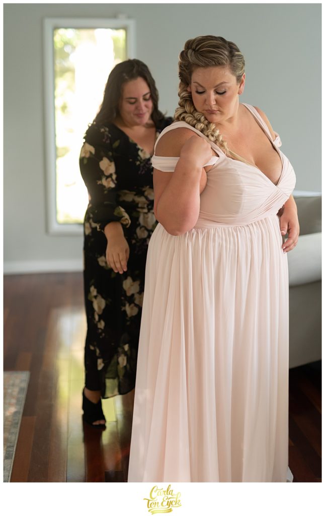 A plus size bride gets ready in her Hayley Paige wedding dress at her LGBTQ wedding