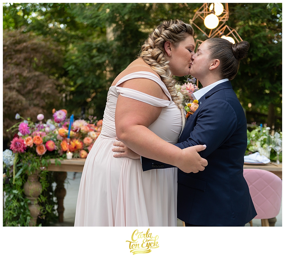 Two brides kiss at their LGBTQ Wedding with Amy Champagne Events