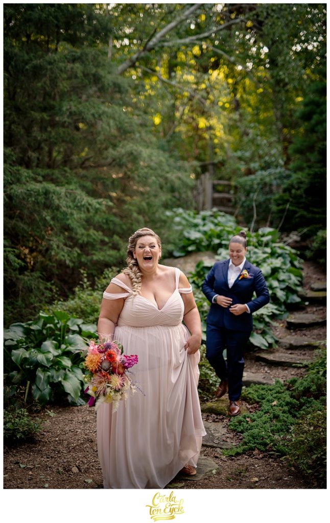Two brides laugh during photos at their LGBTQ wedding in Weston CT