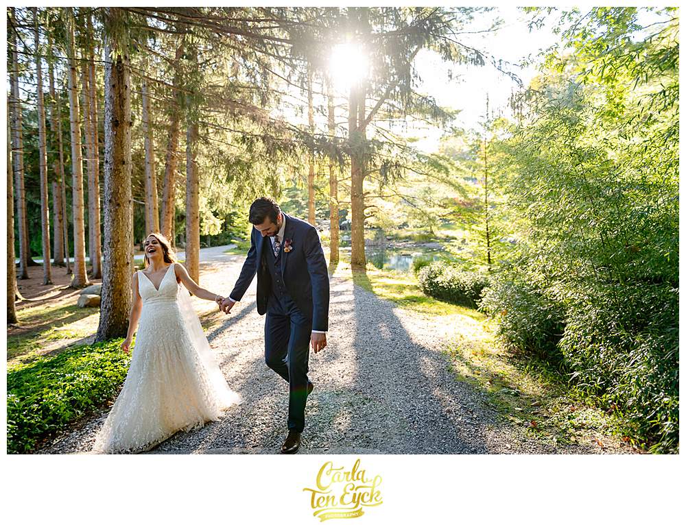 A couple walks thru the woods at their wedding at Chatfield Hollow Inn Killingworth CT