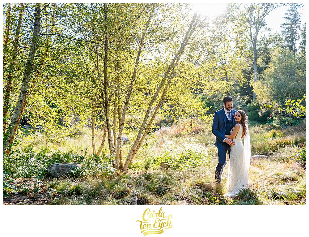 Bride and groom pose for picture sin a field at their intimate wedding at Chatfield Hollow Inn Killingworth CT