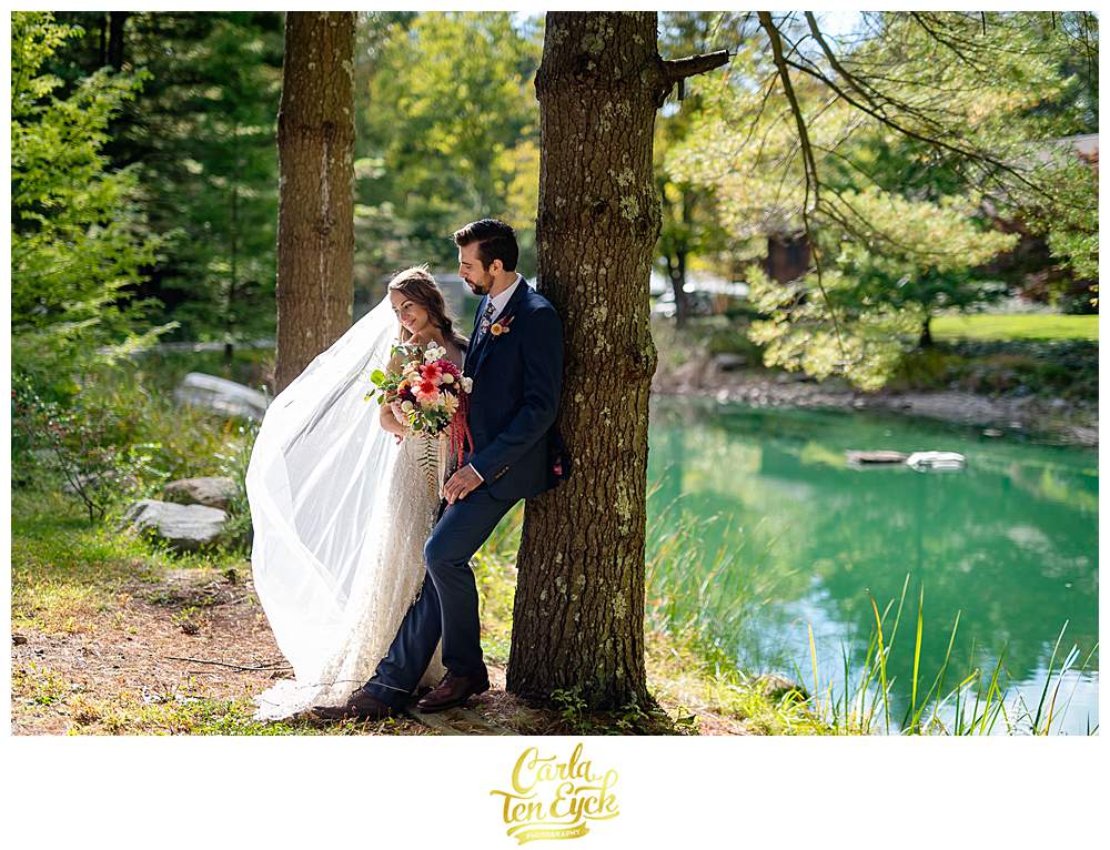 A bride and groom stand near a pond at their Chatfield Hollow Inn Wedding in Killingworth CT
