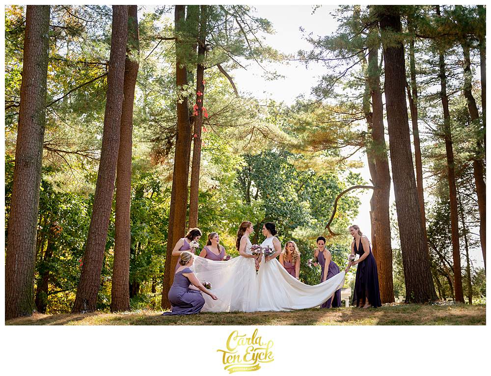 Two brides laugh during their wedding party photos at their wedding at The Wadsworth Mansion, Middletown CT