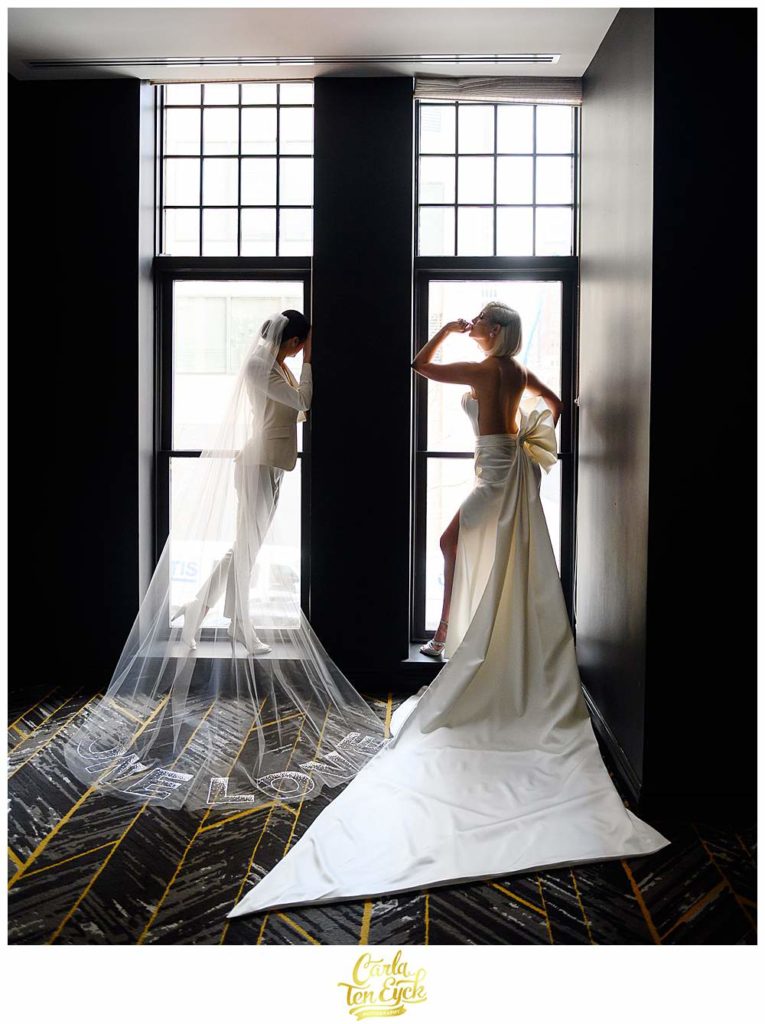Two brides pose for photos during their intimate wedding at the Goodwin Hotel in Hartford CT