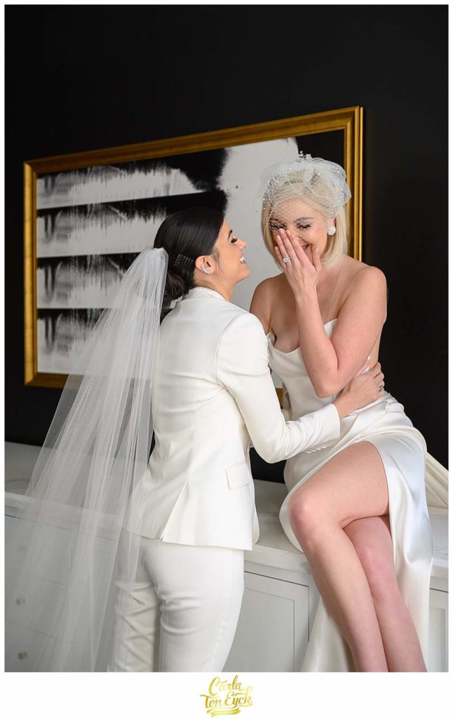 Two brides laugh during their intimate wedding at the Goodwin Hotel in Hartford CT