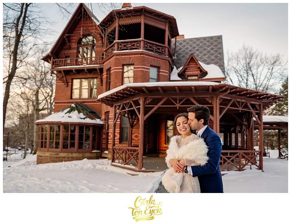 A bride and groom snuggle during their wedding at the Mark Twain House in Hartford CT