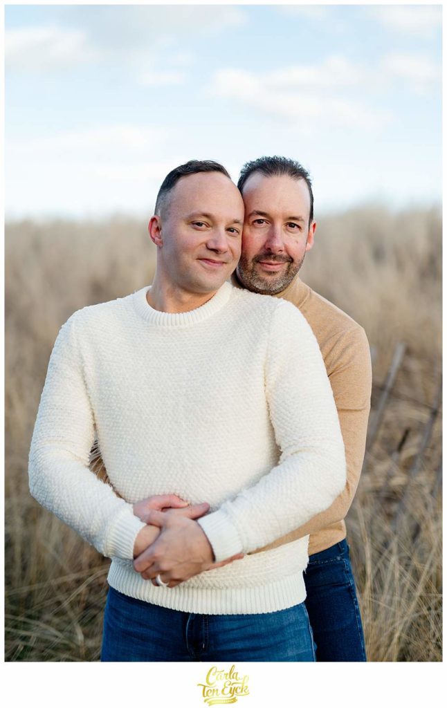 Two grooms snuggle at Silver Sands beach in Milford CT