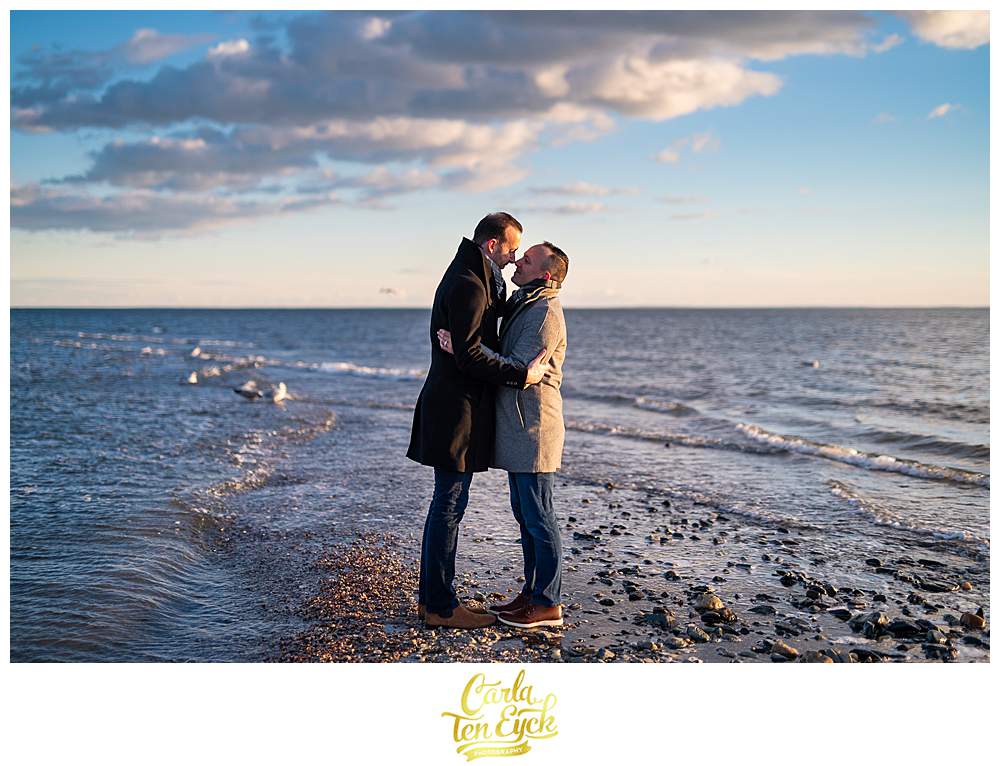 Two grooms during their winter engagement session at Silver Sands beach in Milford CT
