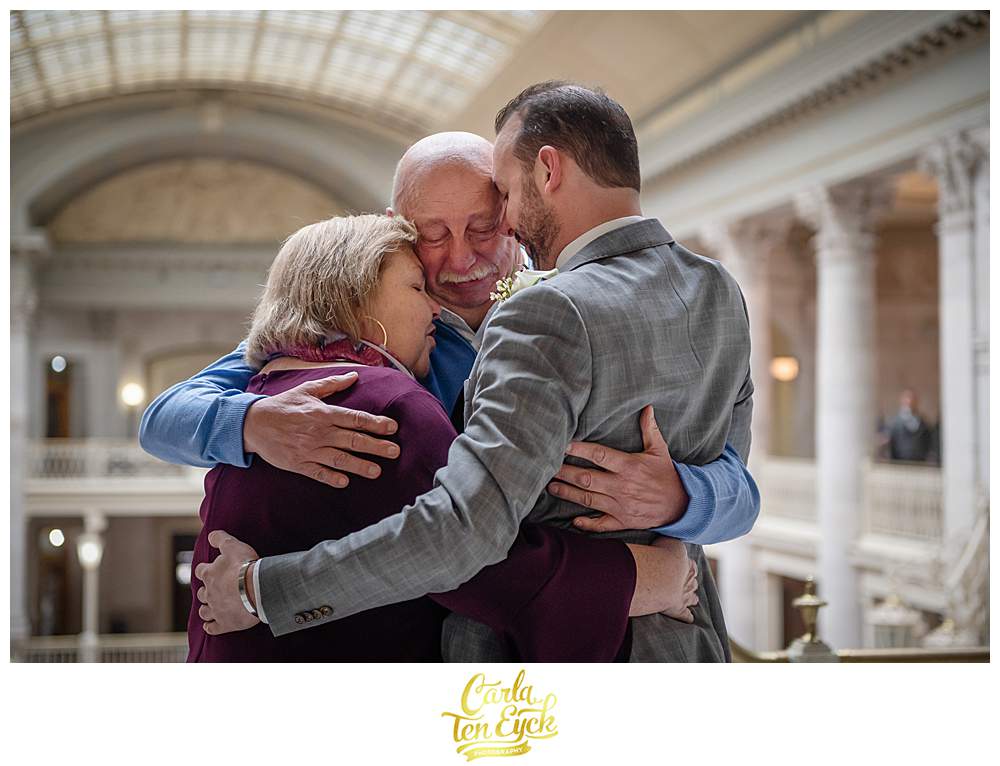 Groom hugs his family at his elopement in Hartford City Hall in Hartford CT
