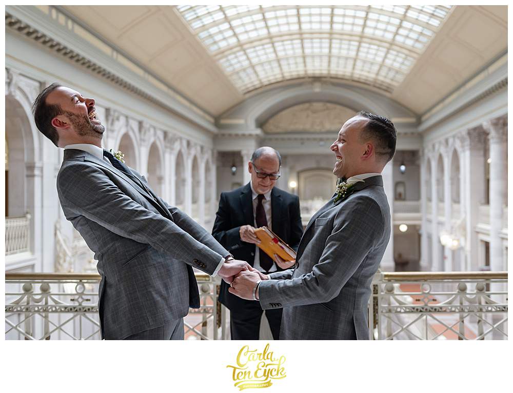 Two groom laugh at their elopement at Hartford City Hall in Hartford CT