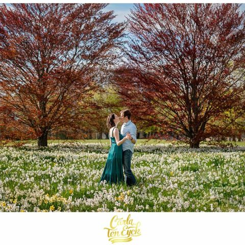 A couple dances in the daffodils in the spring during their Harkness Park engagement session in Waterford CT