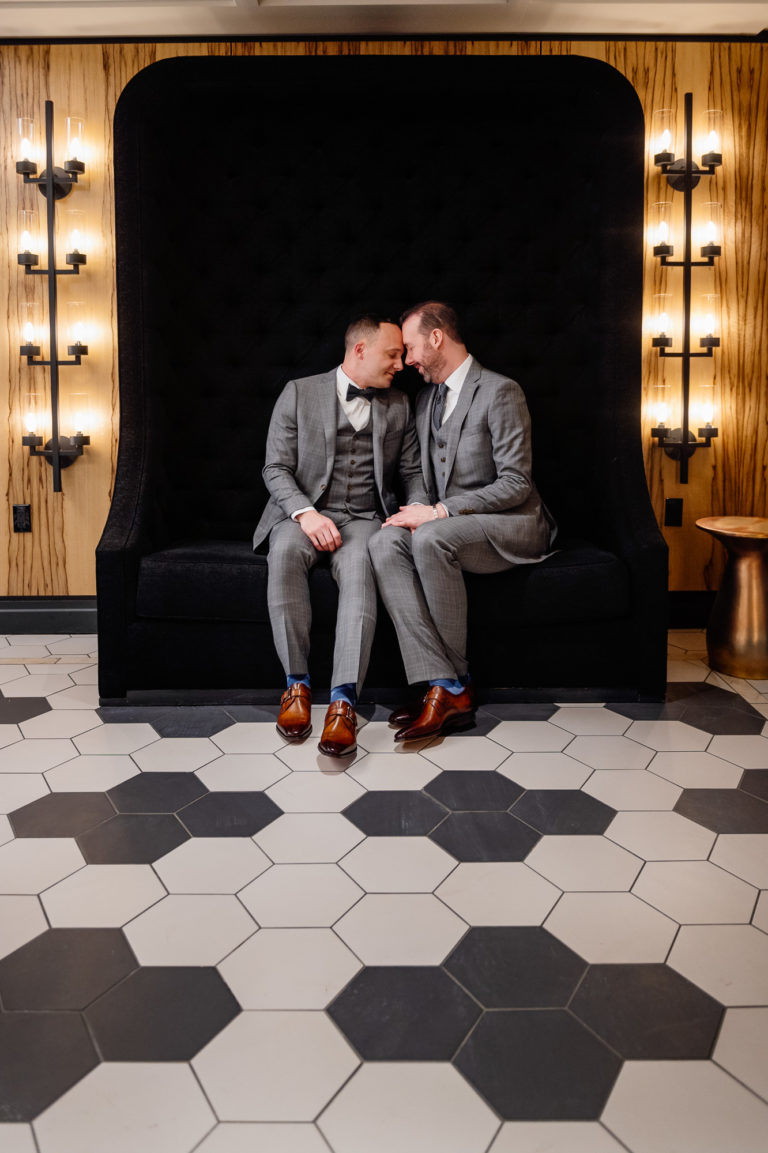Two grooms snuggle for photos during their wedding at Hartford City Hall in Hartford CT