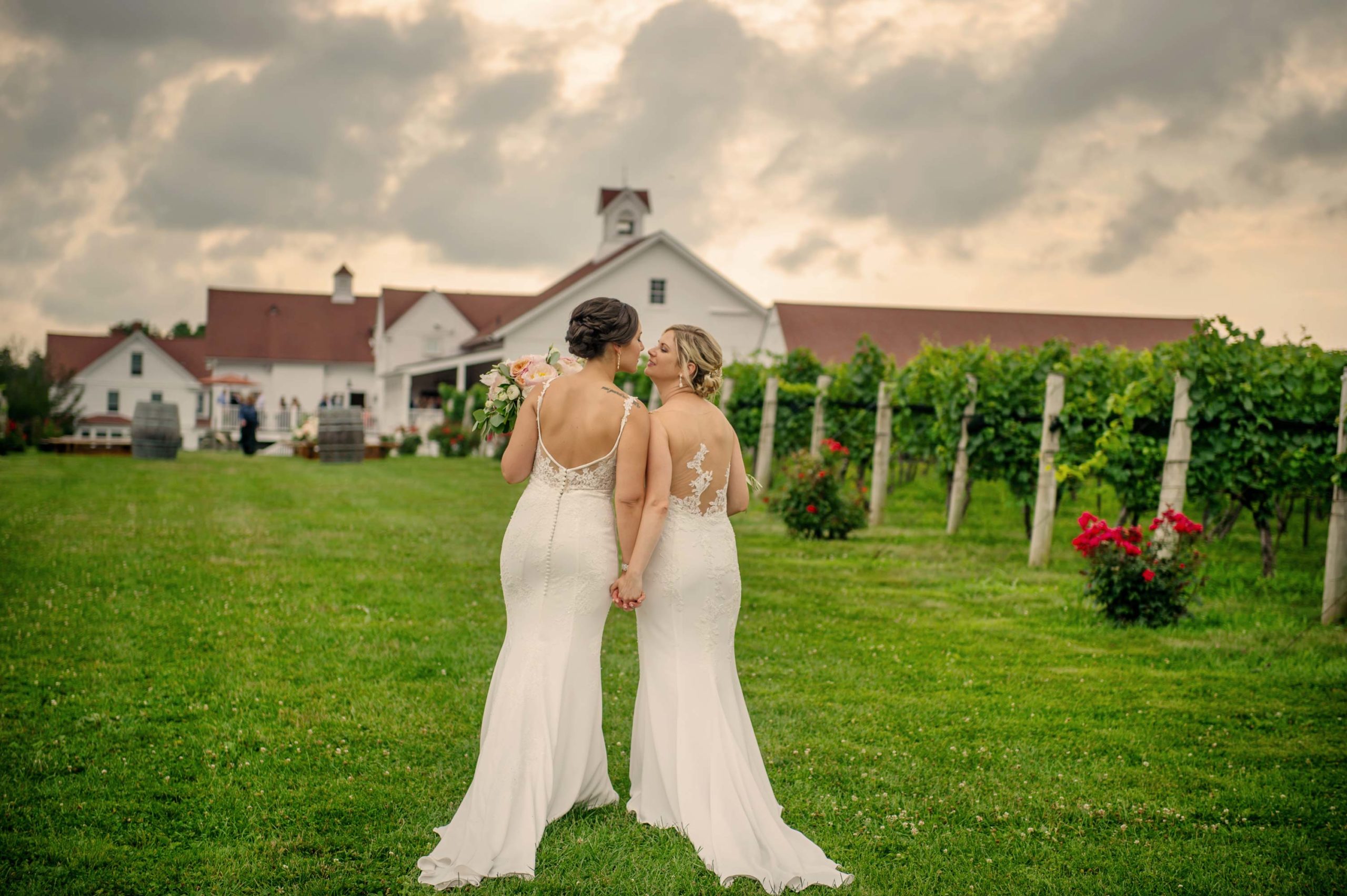 Two brides kiss after their wedding at Jonathan Edwards Winery in North Stonington CT