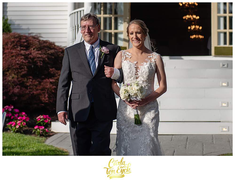 A bride cries as she walks down the aisle with her Dad at her Fox Hill In Wedding in Brookfield CT