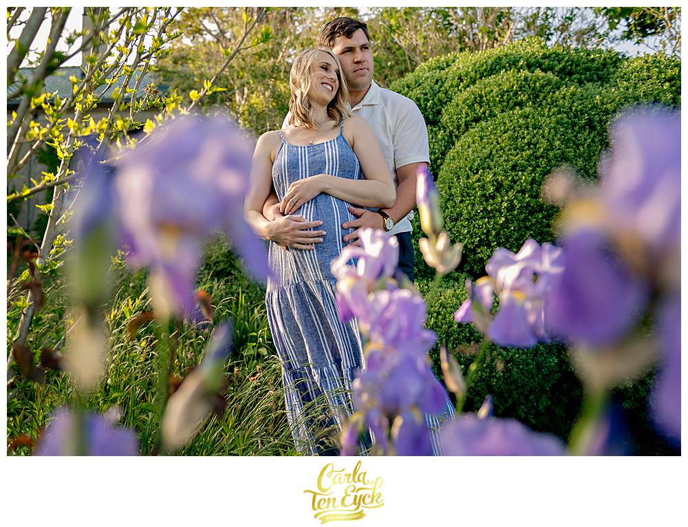 A couple snuggles during their maternity session at Harkness Park in Waterford CT