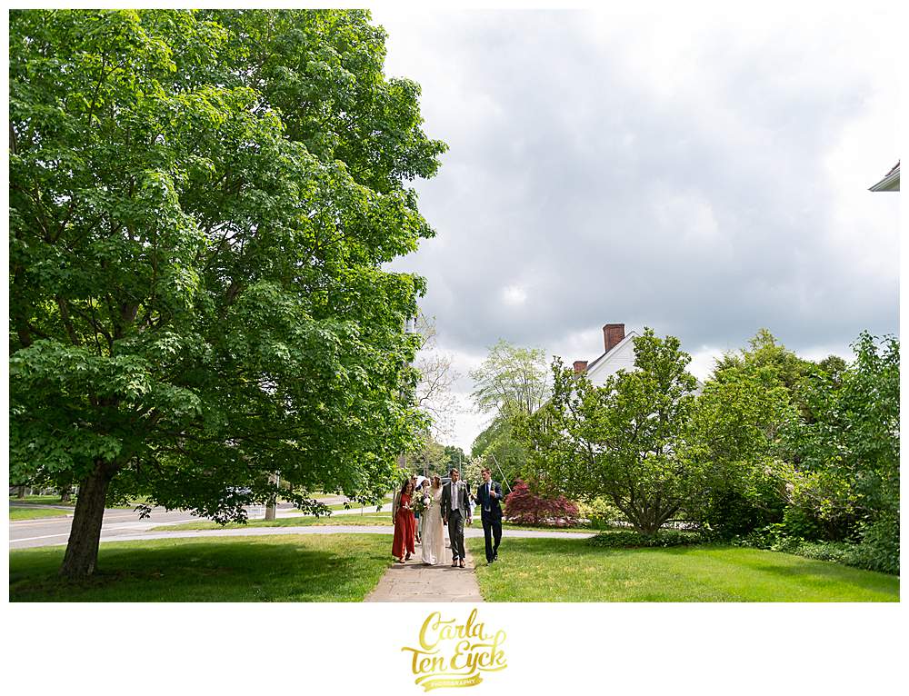 A wedding party walks down the streets after their Litchfield wedding in Litchfield CT