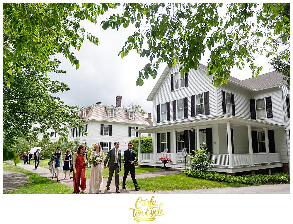 A wedding party walks down the streets after their Litchfield wedding in Litchfield CT