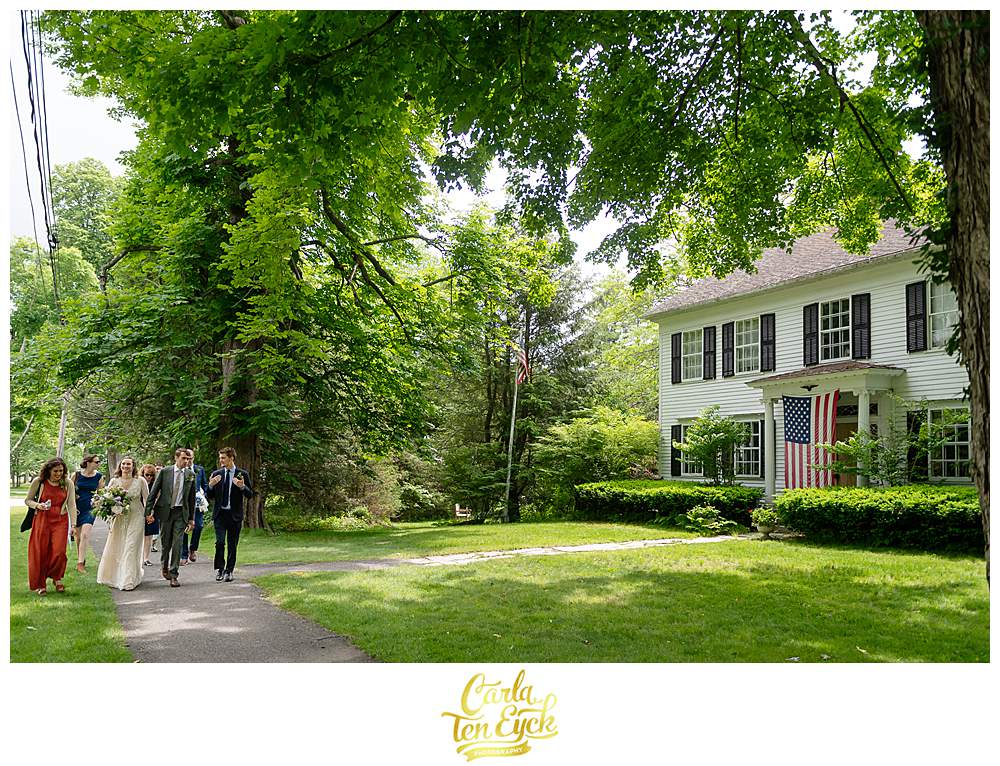 A wedding party walks down the streets after their Litchfield wedding in Litchfield CT