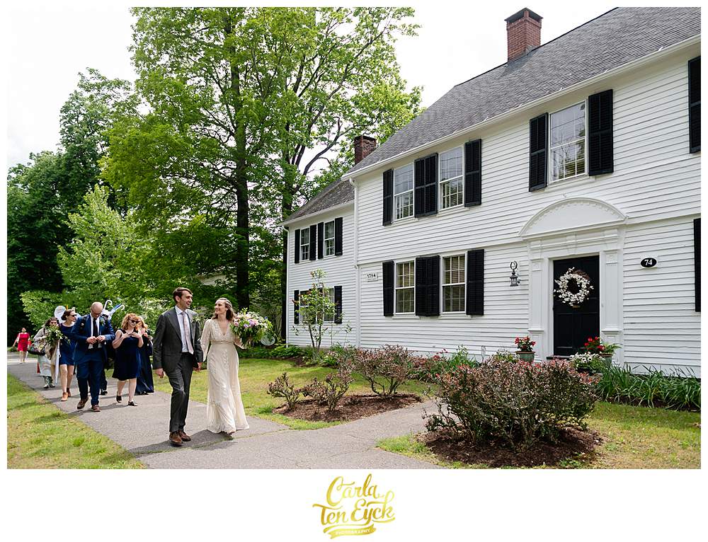 A wedding party walks down the streets after their Litchfield wedding in Litchfield CT
