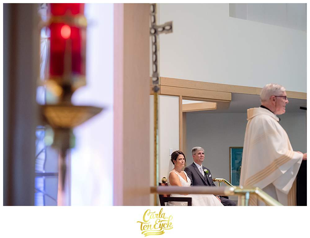 A couple sits during their Fairfield University wedding in Fairfield CT