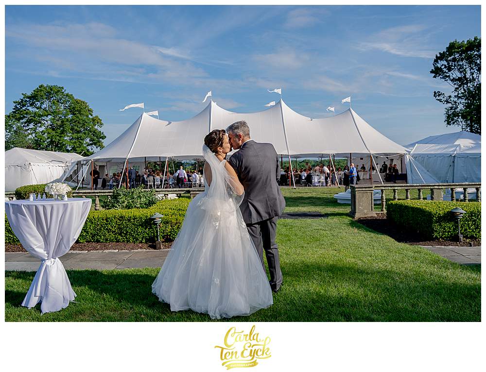 A couple kisses at their wedding at Fairfield University in Fairfield CT