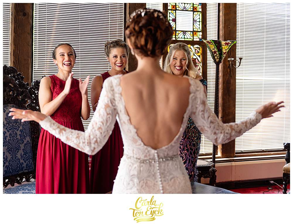 A birde does a first look with her bridesmaids at her Bill Miller's Castle wedding in Branford CT