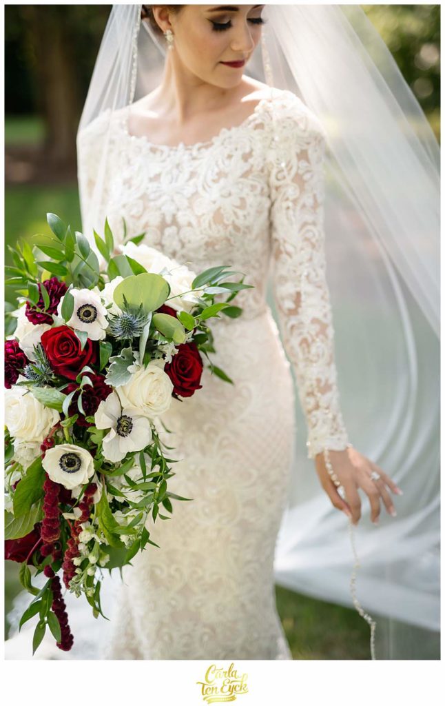 A birde poses for photographs at her Bill Miller's Castle wedding in Branford CT
