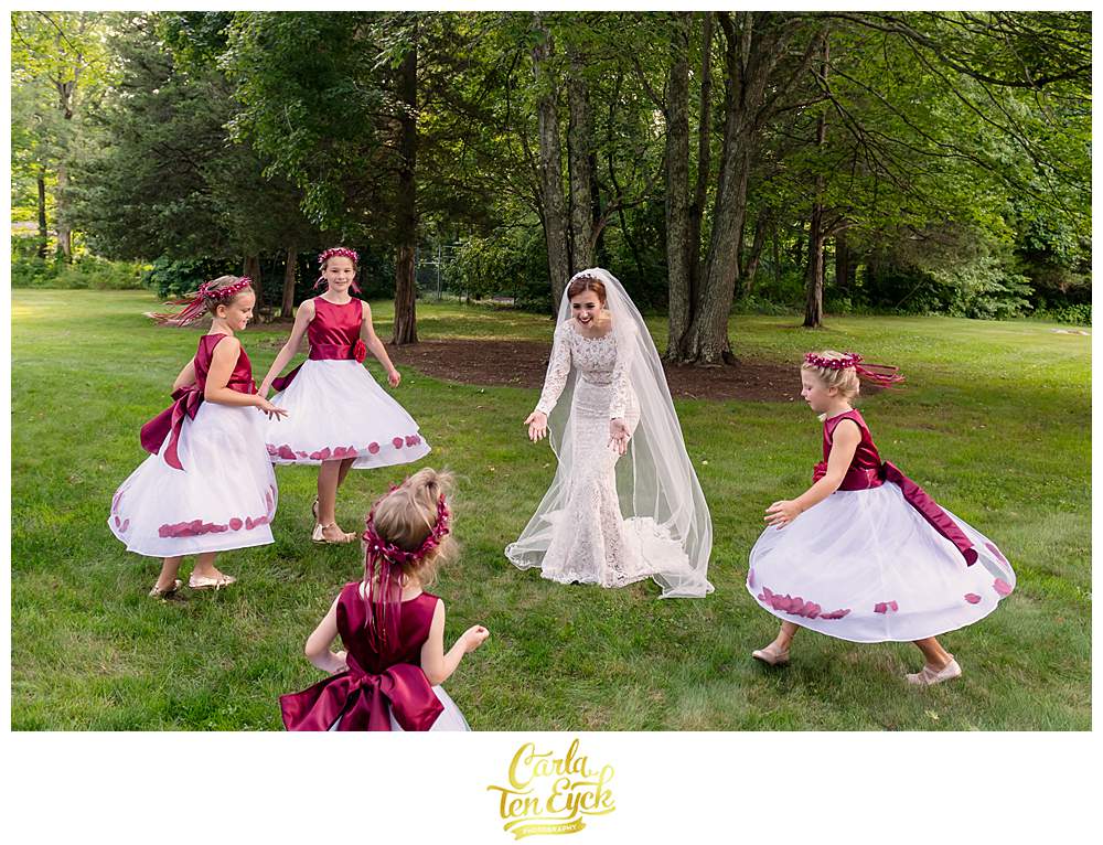 A birde dances with flower girls at her Bill Miller's Castle wedding in Branford CT