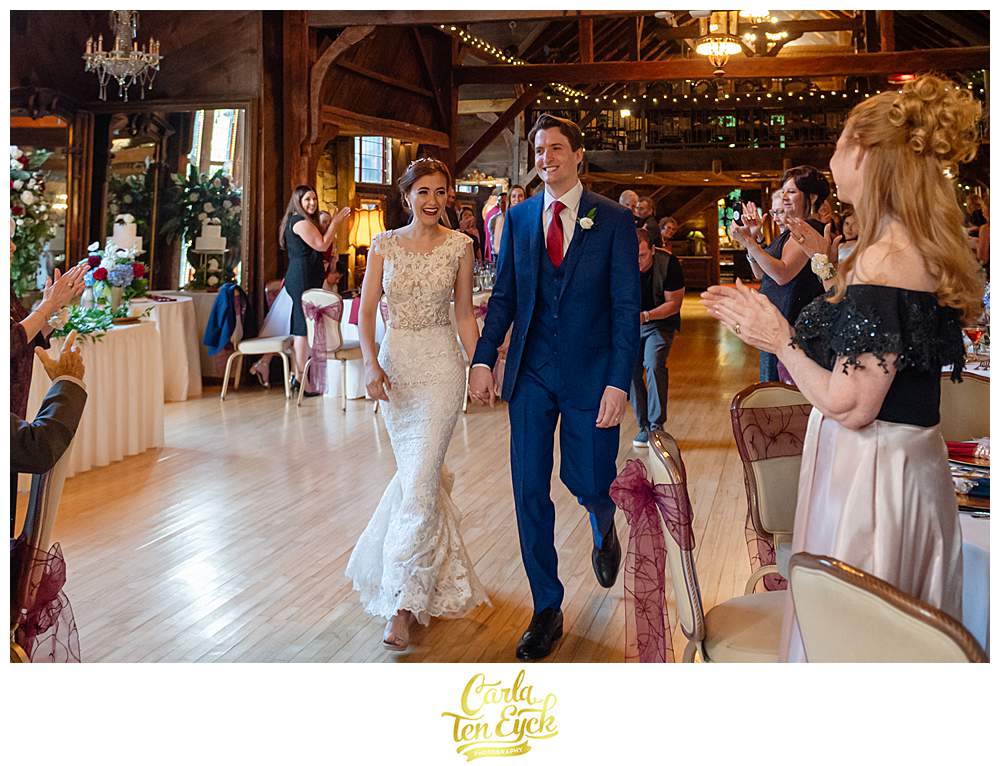A bride and groom make their grand entrance at their Bill Miller's Castle wedding in Branford CT