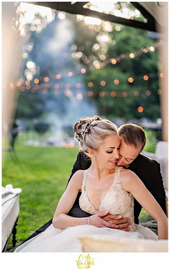 A couple embraces during their Lord Thompson Manor wedding in Thompson CT