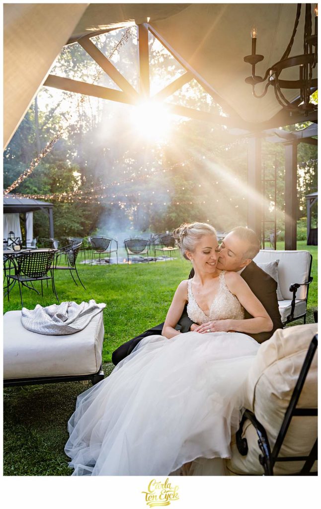 A couple snuggles by the fire at their Lord Thompson Manor wedding in Thompson CT