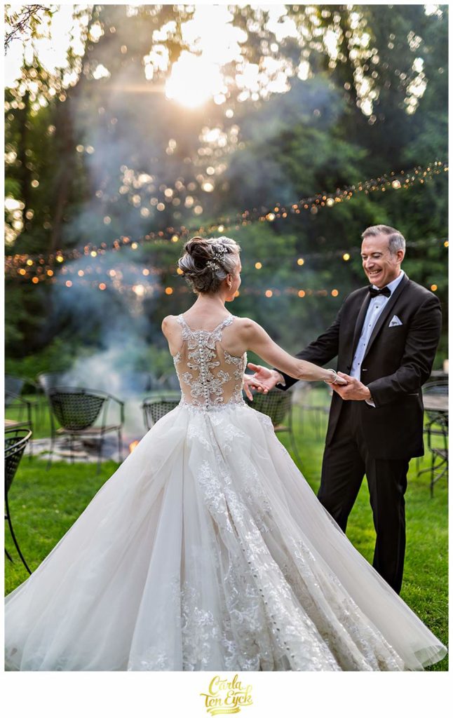 A bride and groom dance during cocktail hour at their Lord Thompson Manor wedding in Thompson CT