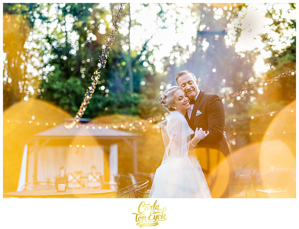 A bride and groom snuggle for photos during their Lord Thompson Manor wedding in Thompson CT