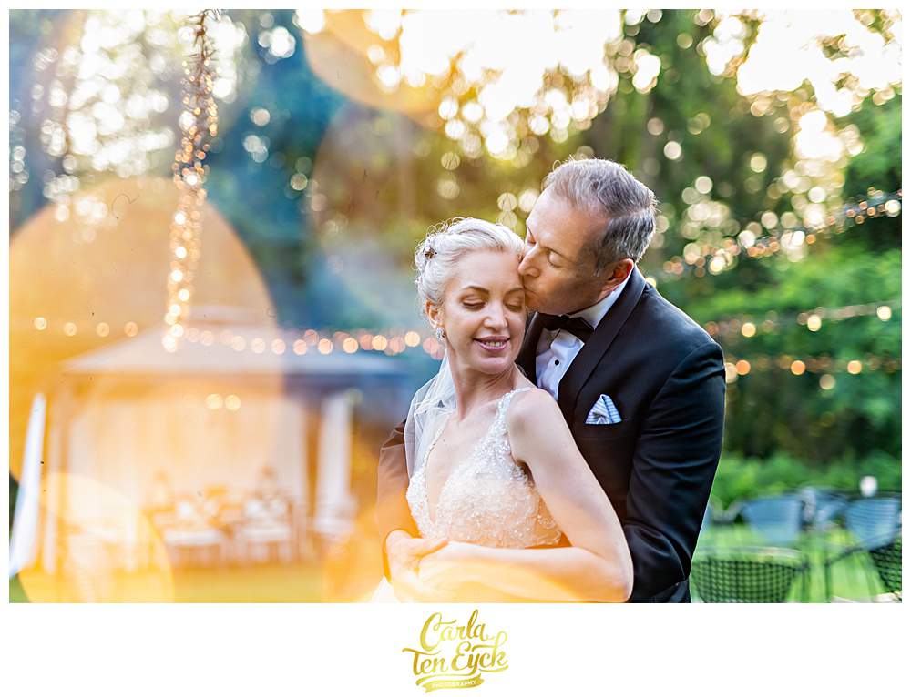 A couple embraces during their Lord Thompson Manor wedding in Thompson CT