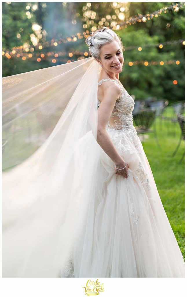 A bride smiles for photos during her Lord Thompson Manor wedding in Thompson CT
