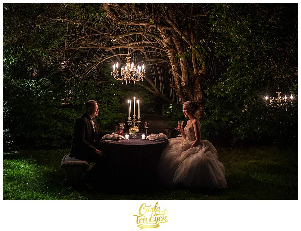 A bride and groom dine by candlelight at their Lord Thompson Manor wedding in Thompson CT