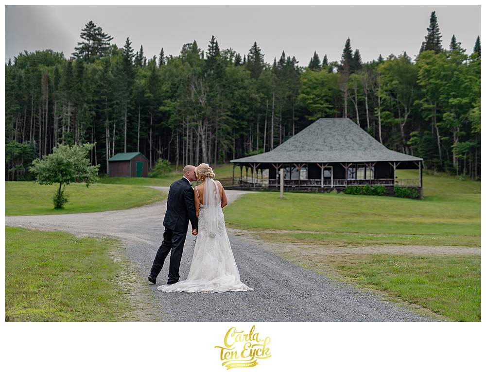 A couple kisses during photos at their New Hampshire wedding.