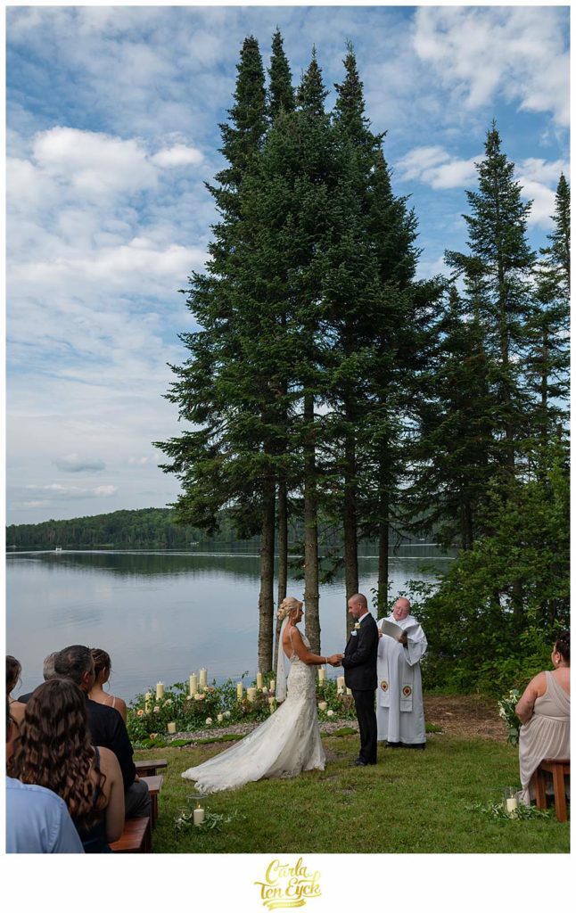 A couple exchanges vows but he lake during their New Hampshire wedding.